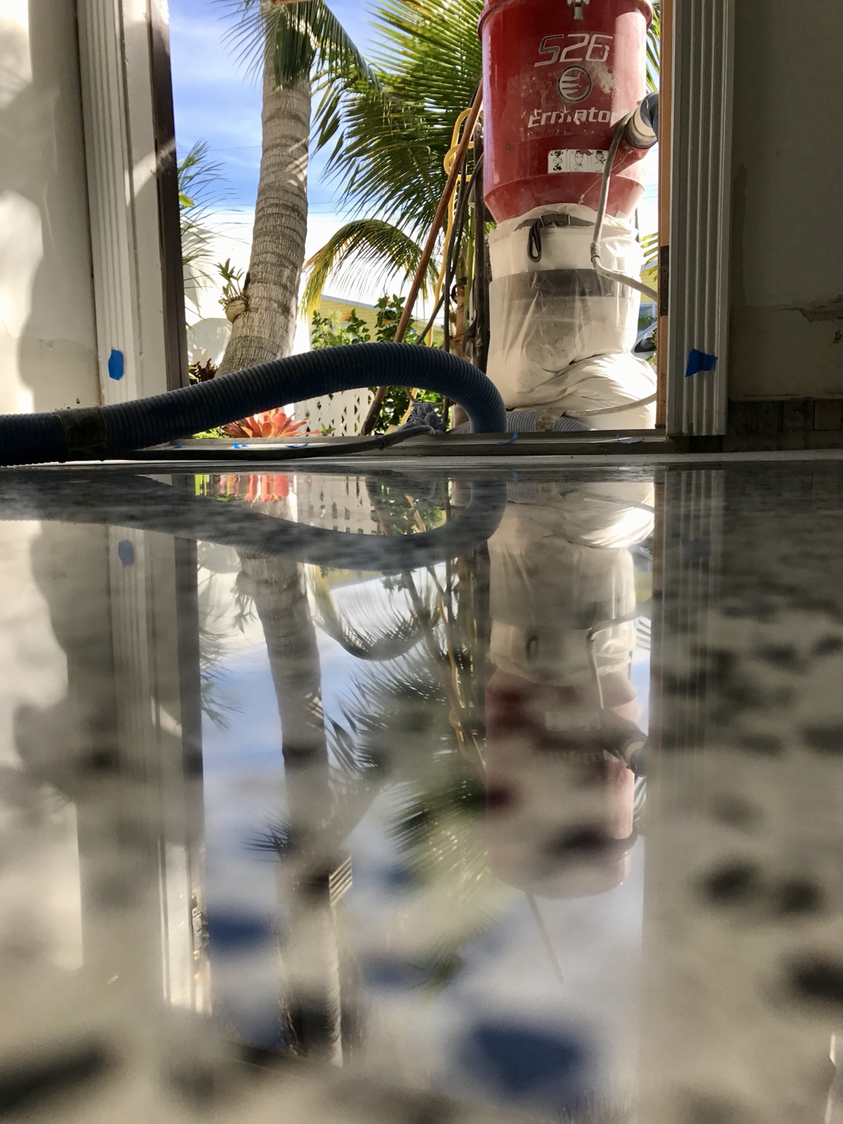 Polished terrazzo with reflections of dust collection equipment