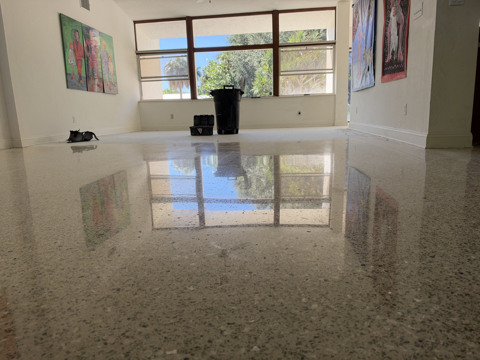 Low view across the restored living room terrazzo, with mother of pearl in the aggregate.