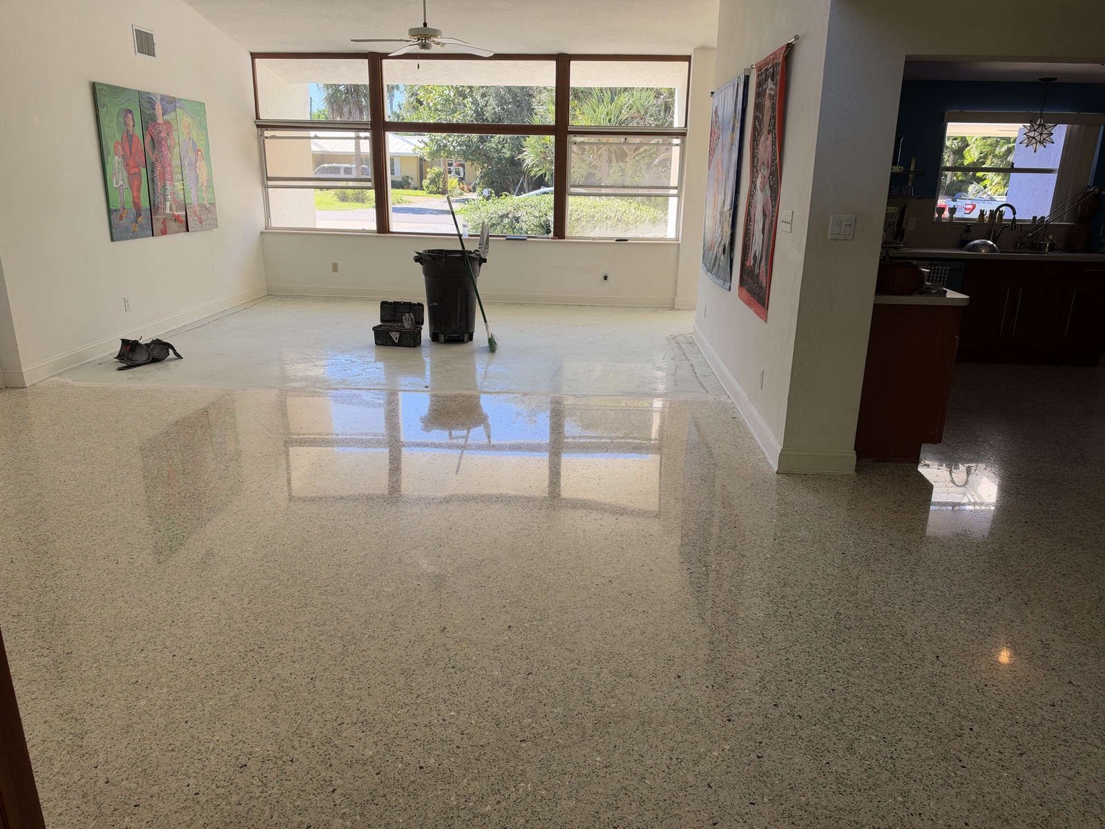 Restored terrazzo in the living room, ending where the concrete floor of the front addition begins.