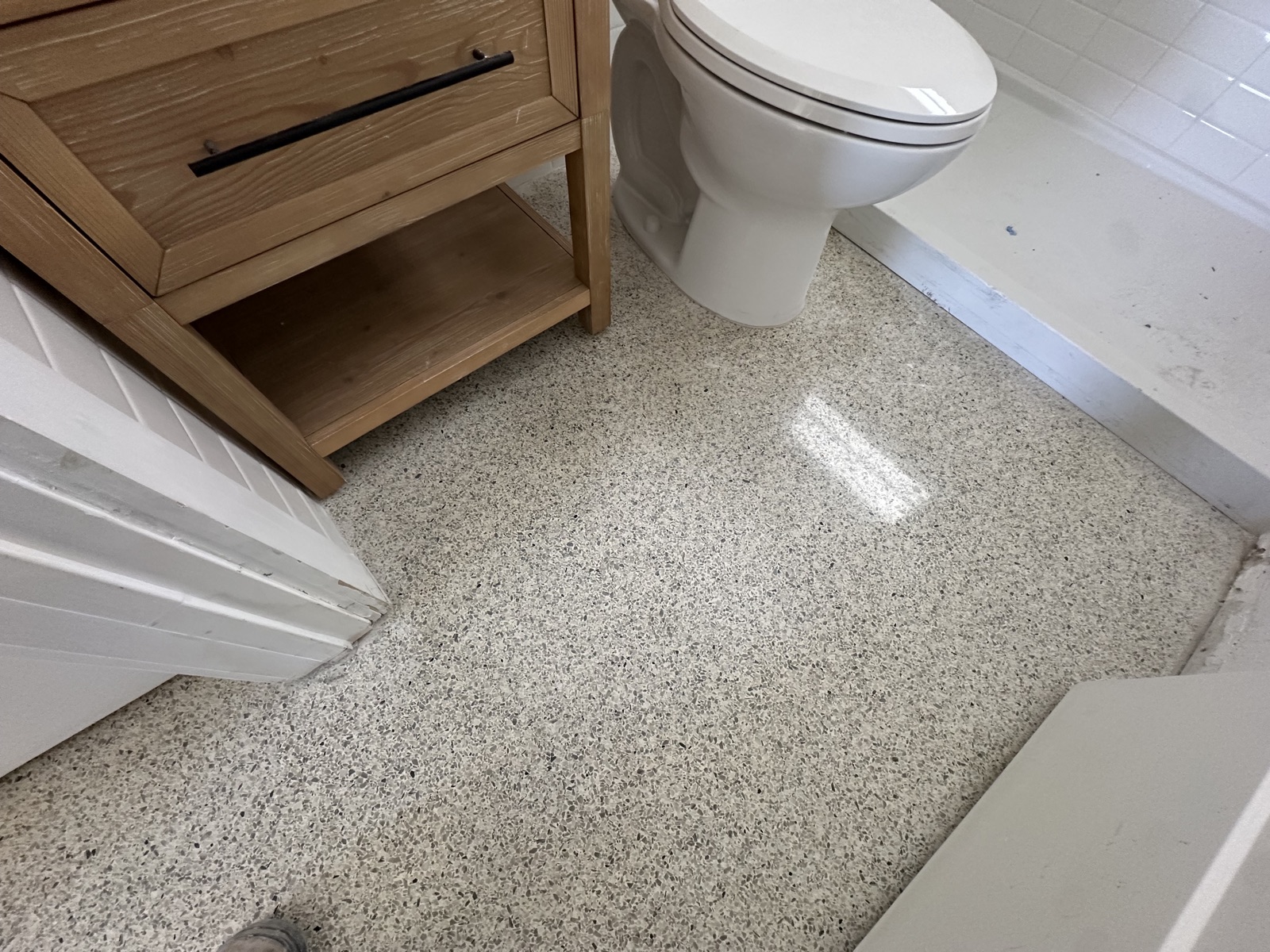 The same bathroom floor after repatching, regrinding and polishing