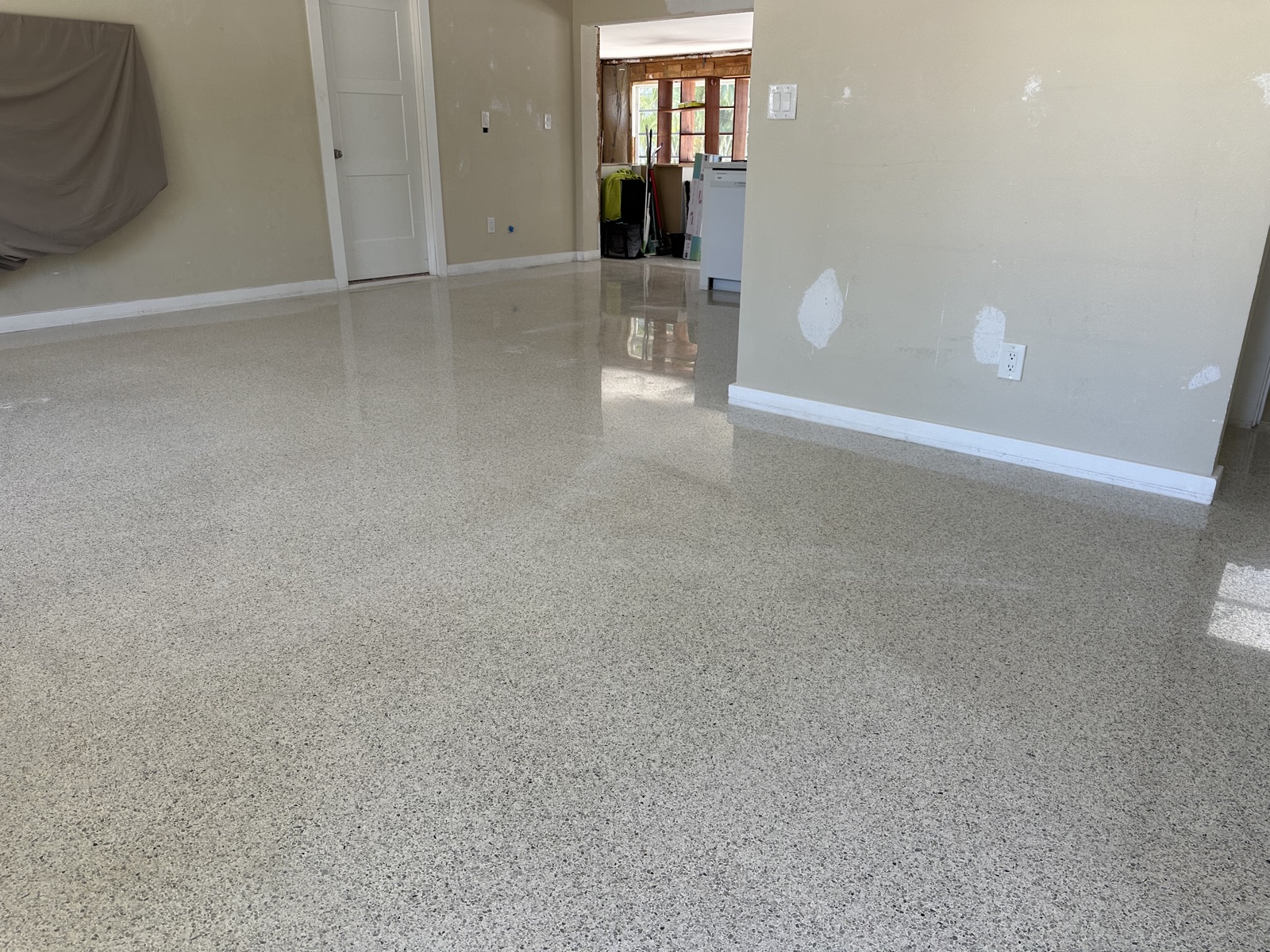 Living room terrazzo after polishing, looking toward the kitchen