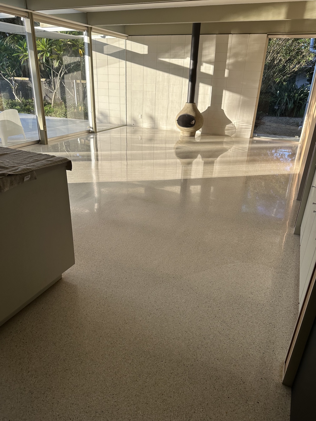 Terrazzo before repolishing, seen from beside the kitchen island toward the living room.