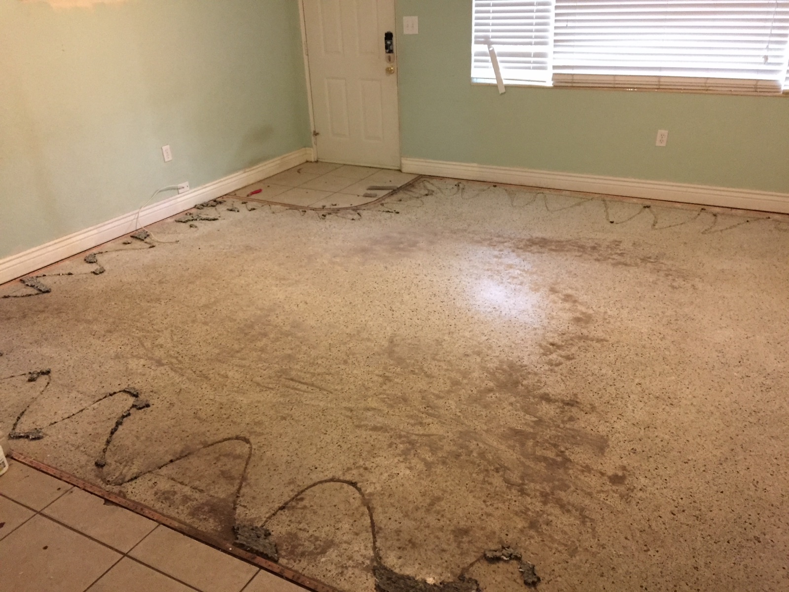Terrazzo floor right after having the carpet removed.
