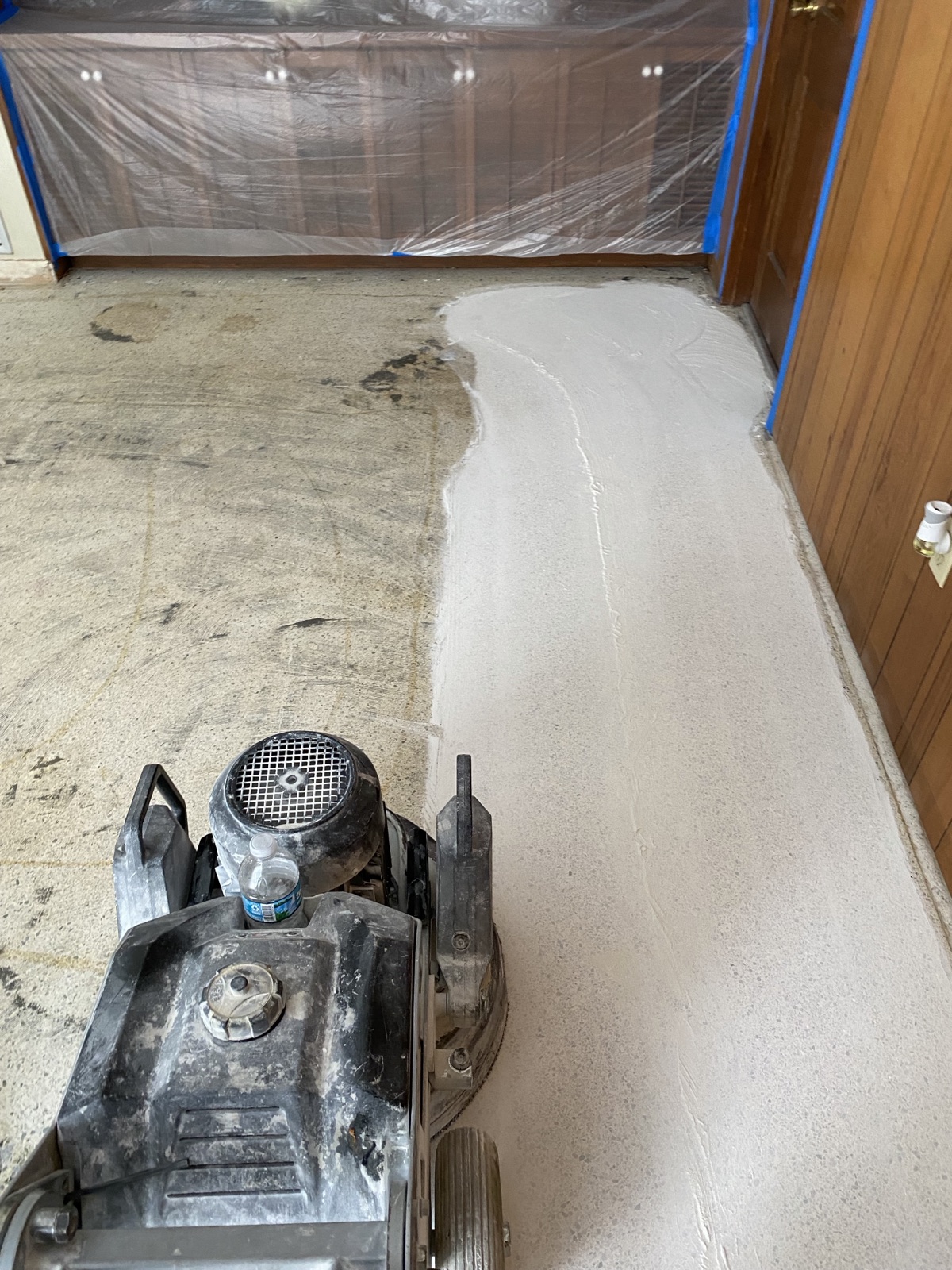A terrazzo floor in the process of getting a rough grind.