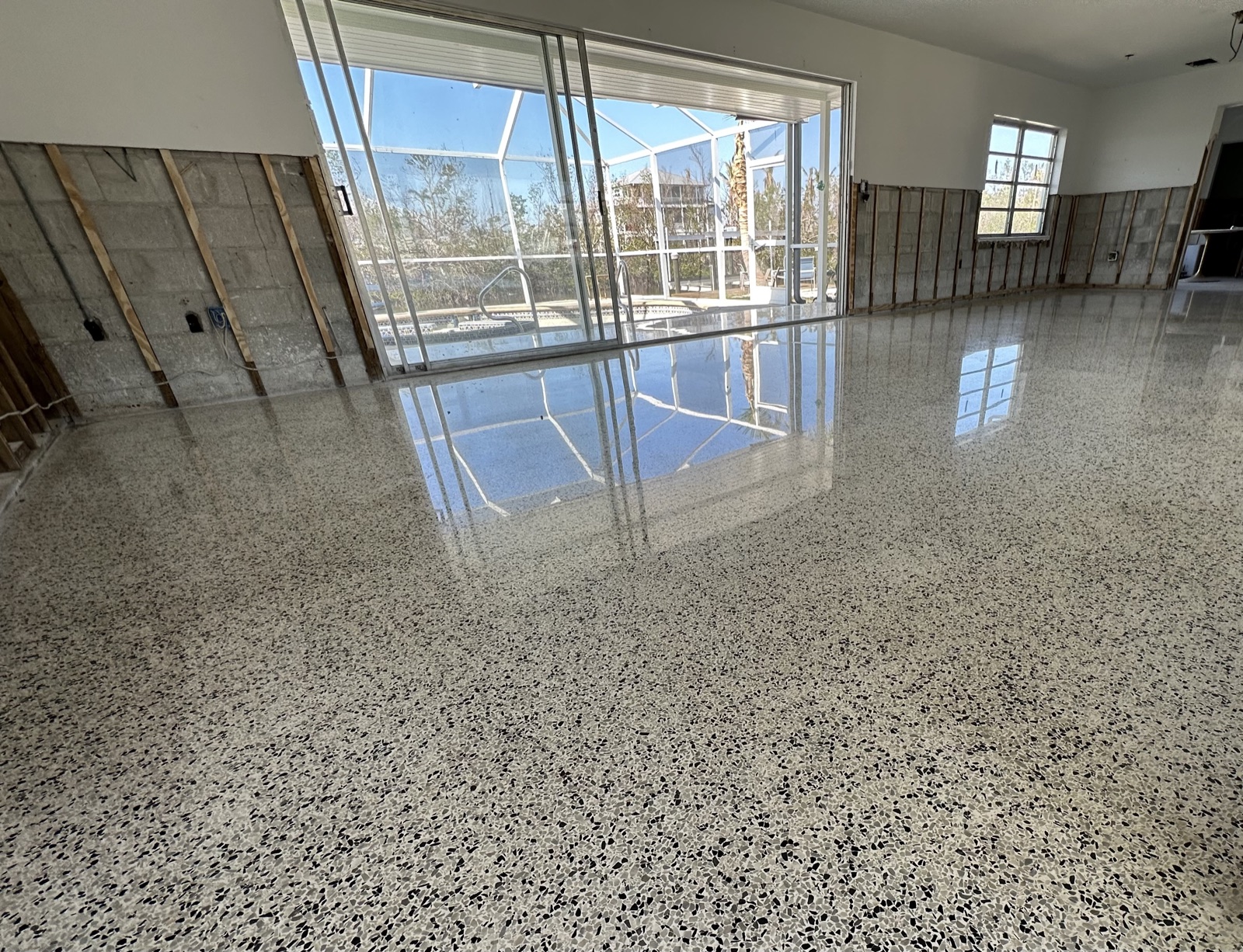 Polished terrazzo in a room where the drywall work has not been completed.