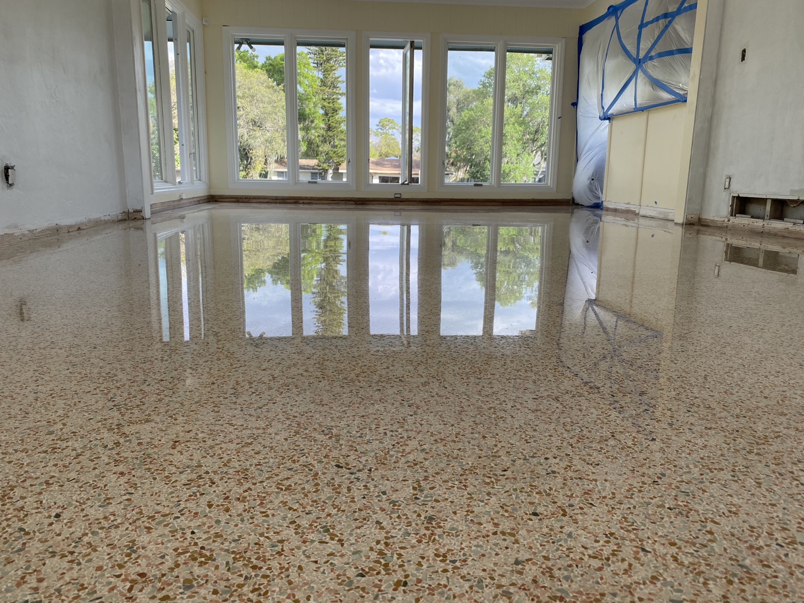 Polished terrazzo reflection facing out a sliding glass door.